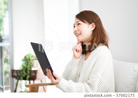 An annoyed woman with a tablet An annoyed woman with a tablet 57002175