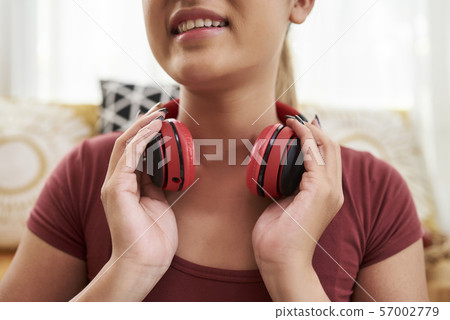 Woman with headphones around neck 57002779