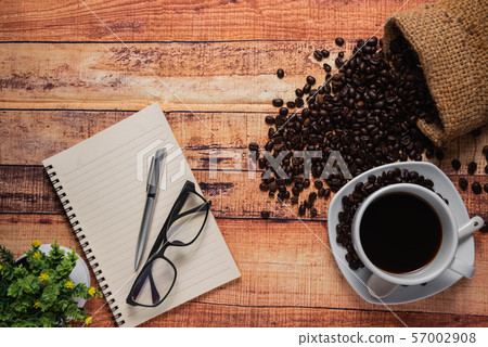 top view, cup of coffee on wood table. Flat lay top view, cup of coffee on wood table. Flat lay 57002908