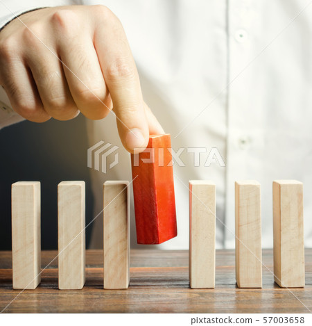 Businessman holds a wooden block in his hands. Businessman holds a wooden block in his hands. 57003658
