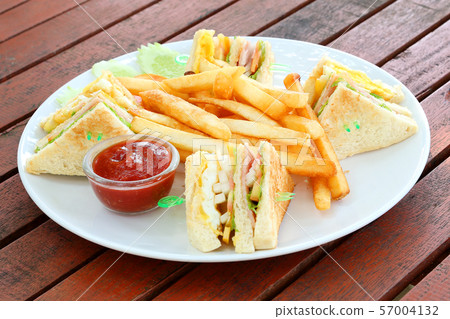French fries with tomato ketchup on wooden French fries with tomato ketchup on wooden 57004132