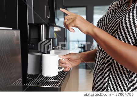 Woman making cup of coffee Woman making cup of coffee 57004795