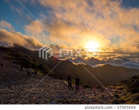 Climbers looking at sunrise from the middle of Mt. 57005689