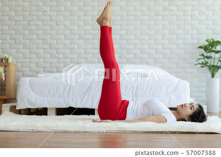 Happy Attractive Asian woman practice yoga leg raises pose with meditation smile with big belly after wake up in the morning Feeling so comfortable and relax,Healthcare Concept Happy Attractive Asian woman practice yoga leg raises pose with meditation smile with big belly after wake up in the morning Feeling so comfortable and relax,Healthcare Concept 57007388
