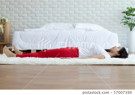 Happy Attractive Asian woman practice yoga Dead Body or Savasana pose with meditation smile with big belly after wake up in the morning Feeling so comfortable and relax,Healthcare Concept 57007389