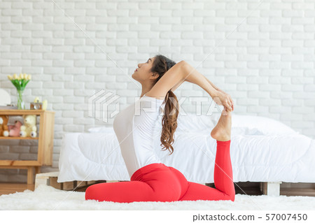 Attractive Asian woman practice yoga king pigeon pose to meditation in bedroom after wake up in the morning Feeling so comfortable and relax,Yoga for Healthcare Concept Attractive Asian woman practice yoga king pigeon pose to meditation in bedroom after wake up in the morning Feeling so comfortable and relax,Yoga for Healthcare Concept 57007450