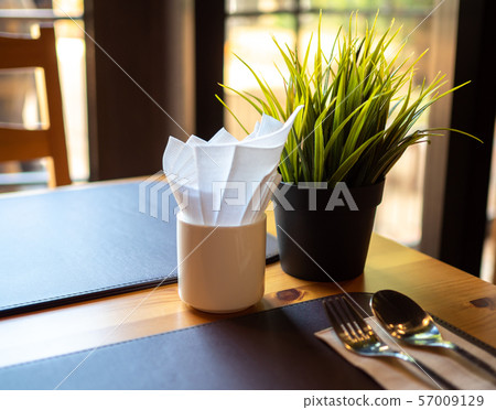 Tree in Flowerpot on dining table with window Tree in Flowerpot on dining table with window 57009129