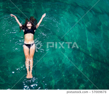 Aerial view of a woman in the sea Aerial view of a woman in the sea 57009678