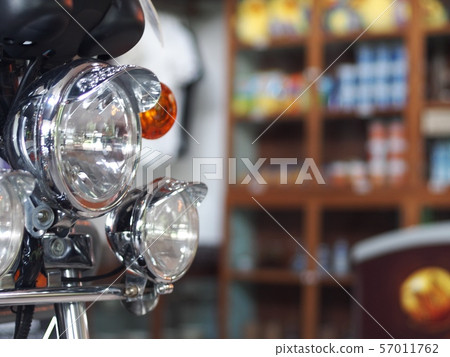 old retro vintage motorcycle front with head and turn signal lamp closeup indoor crop closeup at the headlamp old retro vintage motorcycle front with head and turn signal lamp closeup indoor crop closeup at the headlamp 57011762
