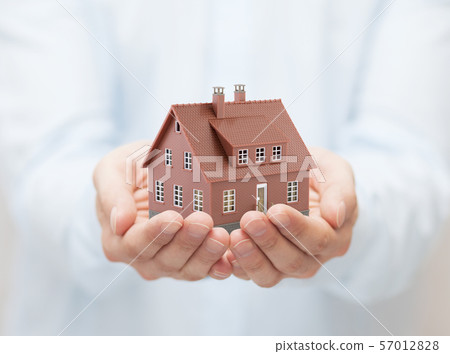 Small brown toy house in hands Small brown toy house in hands 57012828