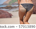 Slender young woman in dressed in black bikini 57013890