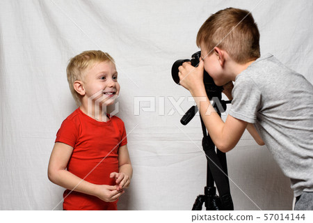 Boys are photographing each other with a SLR 57014144