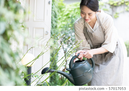 Young woman watering at Jouro Gardening 57017053
