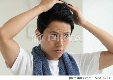 A young Japanese man who prepares his hair 57018741