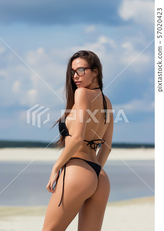 Beautiful woman in swimsuit on beach Beautiful woman in swimsuit on beach 57020423