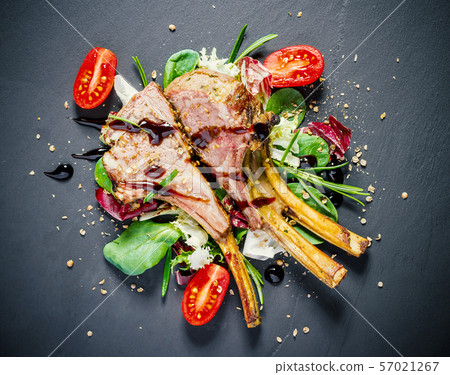 Grilled rack of lamb on slate plate Grilled rack of lamb on slate plate 57021267