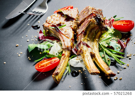 Grilled rack of lamb on slate plate Grilled rack of lamb on slate plate 57021268