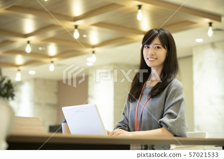 Young woman, warm lighting, office 57021533