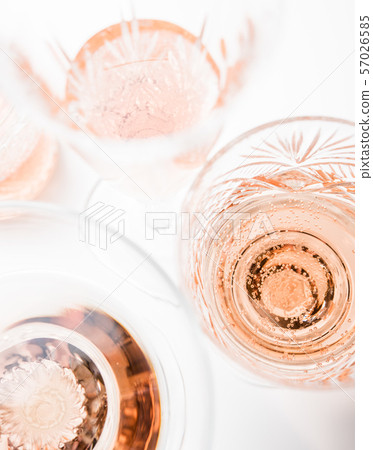 Sparkling rose wine in different glasses on white background Sparkling rose wine in different glasses on white background 57026585