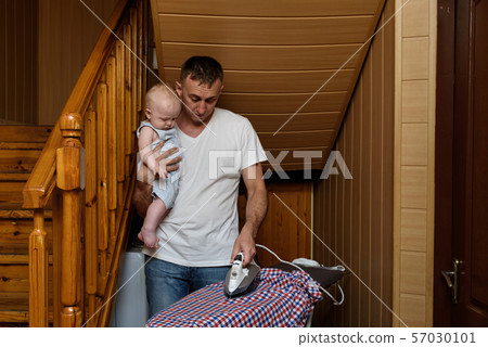 Father with a small baby in her arms ironed linen. Father with a small baby in her arms ironed linen. 57030101