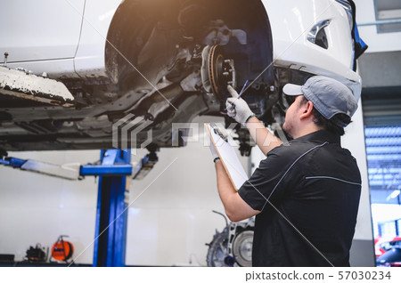 Asian male car technician car maintenance for 57030234