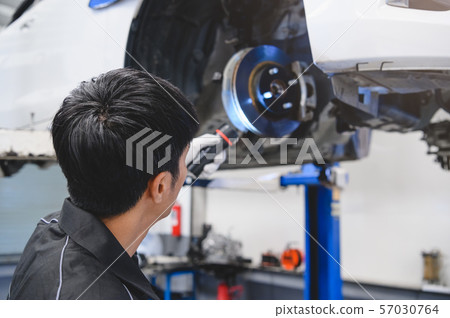 Asian male mechanical hold and shining flashlight 57030764