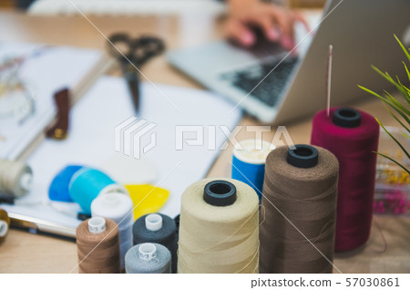 Closeup of sewing equipment on fashion designer 57030861