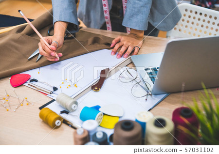 Closeup of attractive female fashion designer hand Closeup of attractive female fashion designer hand 57031102