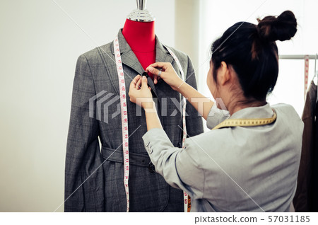 Asian female fashion designer girl making fit on Asian female fashion designer girl making fit on 57031185