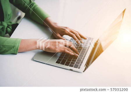 Closeup of woman hand working at home office and Closeup of woman hand working at home office and 57031200