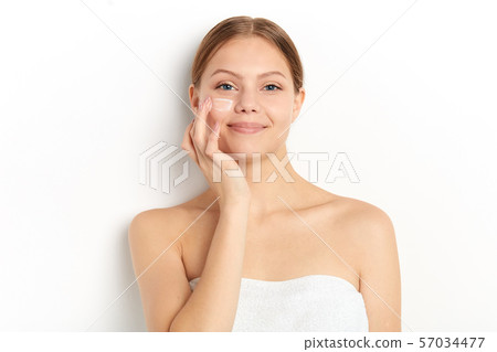 smiling girl massaging her face , taking care of skin smiling girl massaging her face , taking care of skin 57034477