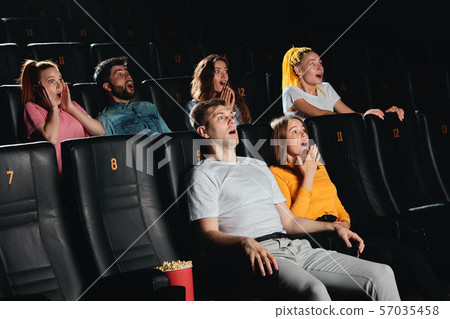 Young scared couple screaming at the cinema 57035458