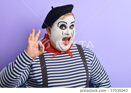 funny fat man in stiped sweater and black beret expresses agreement funny fat man in stiped sweater and black beret expresses agreement 57036043