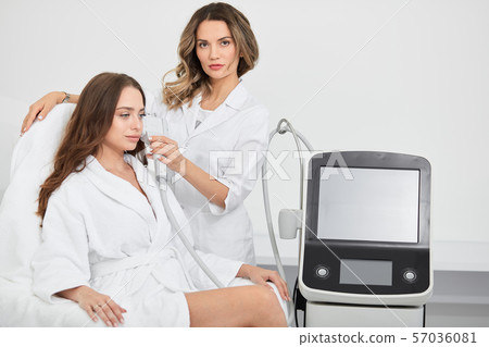 young lovely woman getting beauty treatmnet procedure 57036081