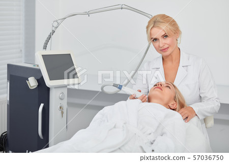 cosmetologist massaging client.s facial skin cosmetologist massaging client.s facial skin 57036750