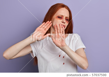 scared ginger woman with closed eyes stretching out hand scared ginger woman with closed eyes stretching out hand 57037500