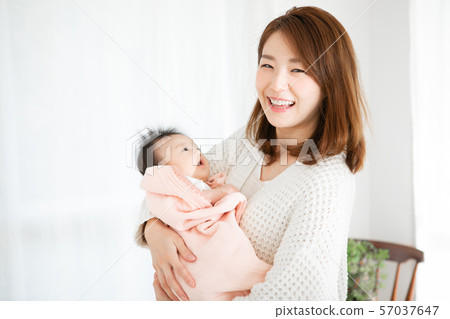 Mother holding a baby Mother holding a baby 57037647