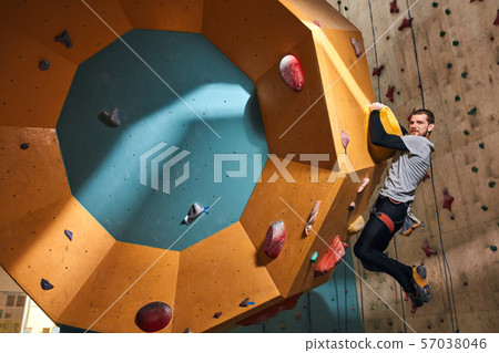 Young climber with physical disability training indoors, overhanging at difficult wall Young climber with physical disability training indoors, overhanging at difficult wall 57038046