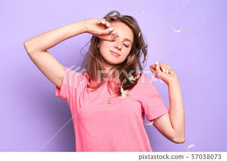 Relaxed girl has delightful expression, stretches after healthy long sleep Relaxed girl has delightful expression, stretches after healthy long sleep 57038073