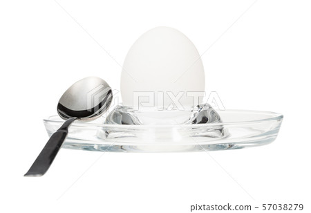 side view of boiled egg and spoon in glass egg cup side view of boiled egg and spoon in glass egg cup 57038279