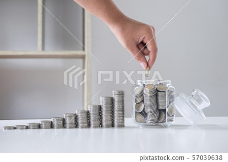 Images of growing stacking coins and Hand putting 57039638