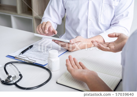 Doctor consulting with patient and checking 57039640