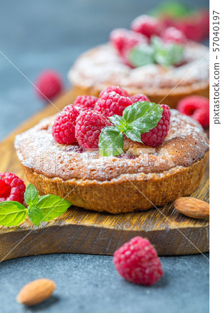 Delicious mini-tarts (tartlets) with raspberries. 57040197