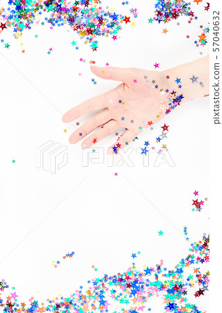 Woman hand with festive color star confetti Woman hand with festive color star confetti 57040632