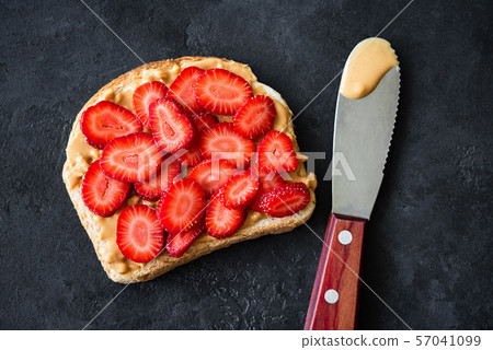 Peanut butter toast with fresh strawberries 57041099