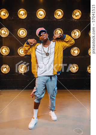 Black rapper in cap, perfomance on stage 57041515