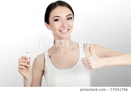 Beautiful Woman Holding Broken Cigarette. Quitting Cigarettes Beautiful Woman Holding Broken Cigarette. Quitting Cigarettes 57041766