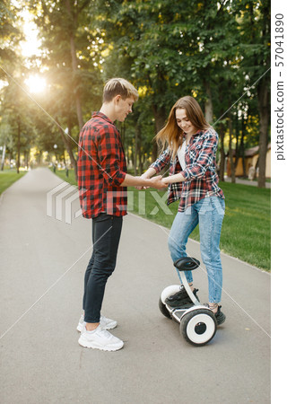 Boyfriend teaches his girl to ride on gyro board 57041890