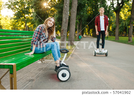 Couple leisures with gyro board in summer park 57041902