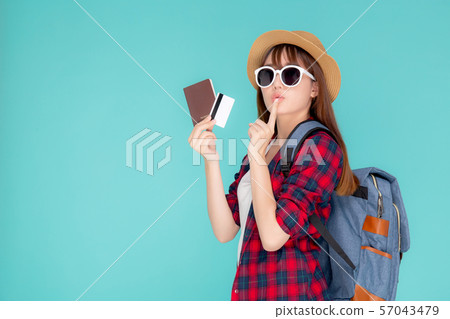 Beautiful young asian woman wear hat and sunglasses with showing credit card and passport thinking 57043479